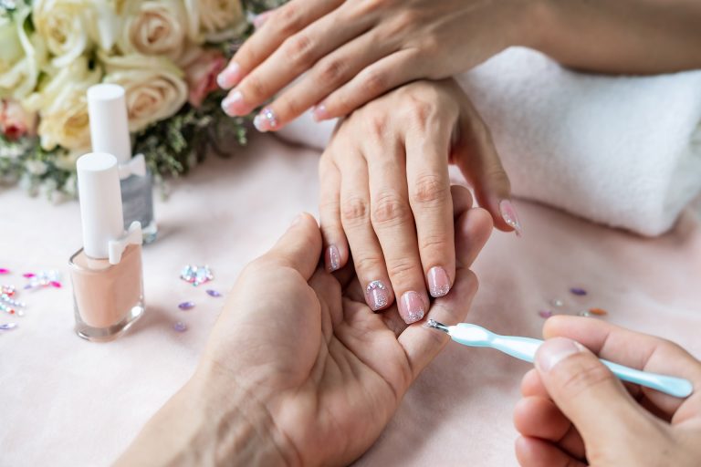 A beautiful nail painted with glitters on the edge.