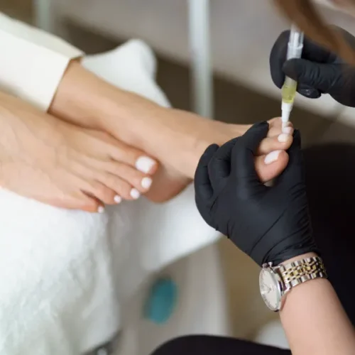 A woman's feet having a pedicure in a nail salon.